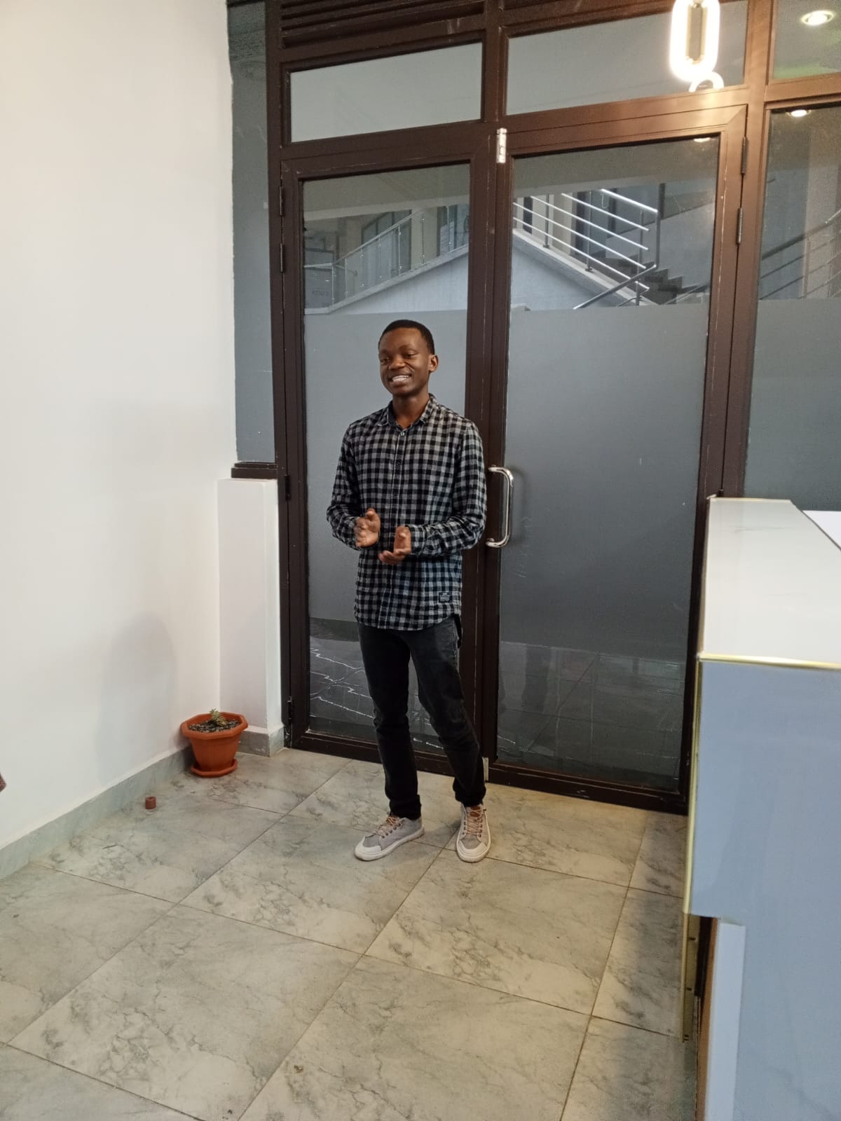 Portrait of a Jarvis Wuod smiling next to a door